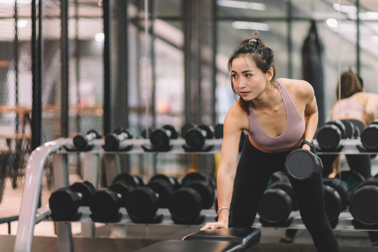 asian chinese female dumbell workout exercise at gym