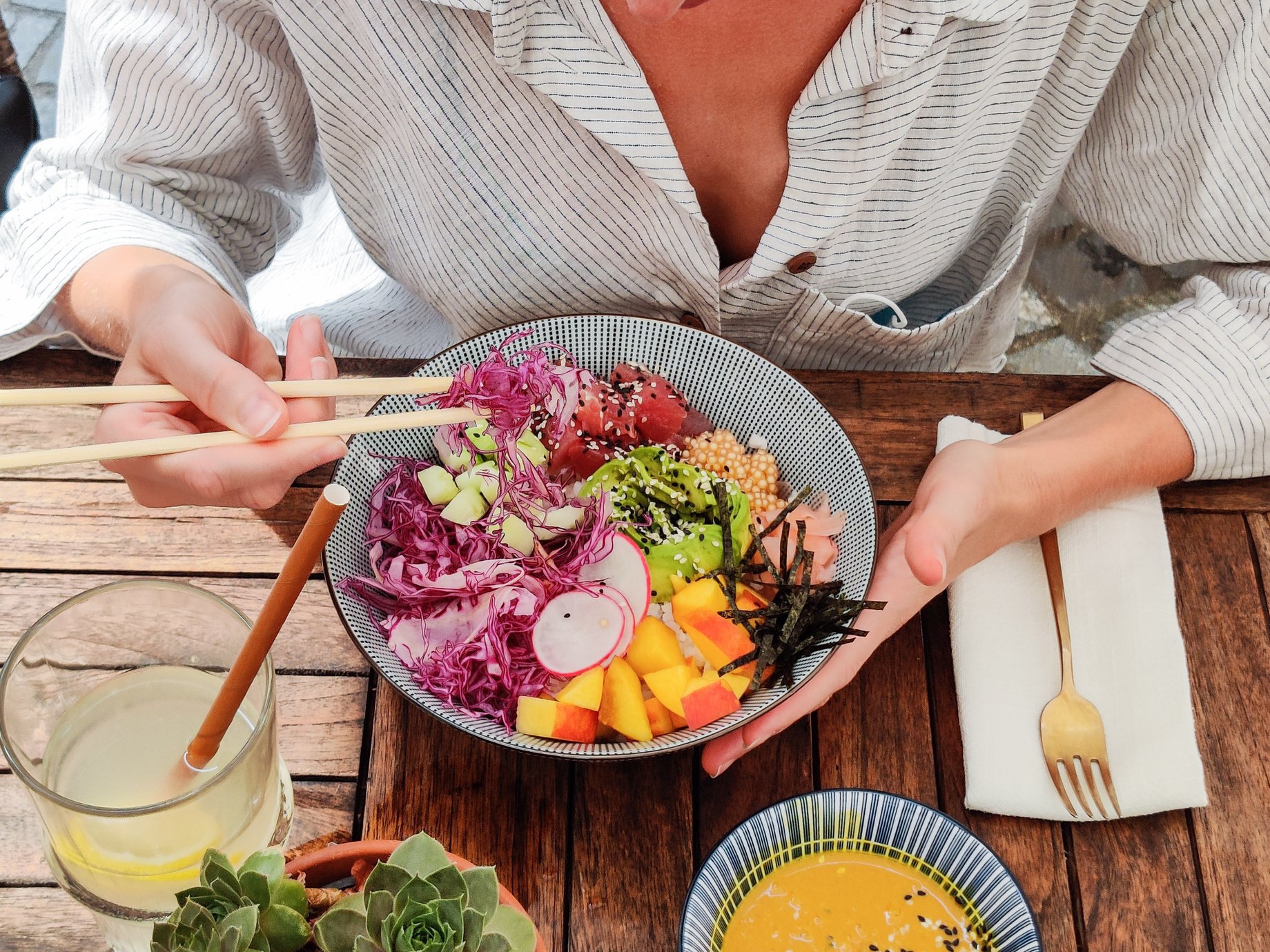 Woman Eating Vegetable Meal Using Chopsticks 